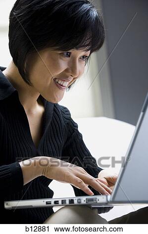 Woman working on laptop View Large Photo Image Stock Image - Woman working on laptop. Fotosearch