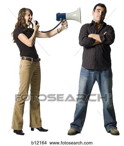 Woman yelling at man through megaphone View Large Photo Image Picture - Woman yelling at man through megaphone. Fotosearch