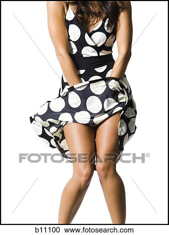 Woman's polka dot dress blowing in breeze View Large Photo Image Stock Image - Woman's polka dot dress blowing in breeze. Fotosearch