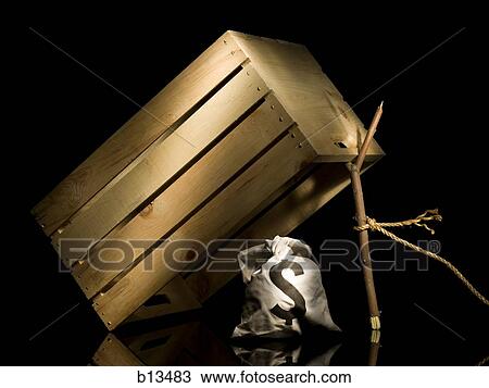 Stock Image - Wooden crate with branch and money bag. Fotosearch