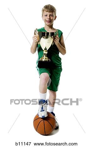 Stock Photo - Young basketball player holding trophy. Fotosearch