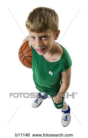 Stock Photograph - Young boy playing basketball. Fotosearch