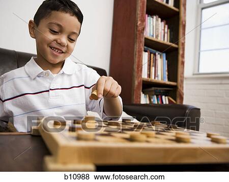 Stock Photo - Young boy playing checkers. Fotosearch