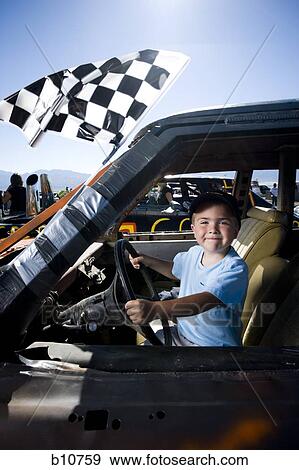 Stock Photo - Young boy pretending to drive. Fotosearch