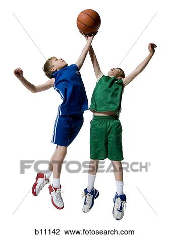 Stock Image - Young boys playing basketball. Fotosearch