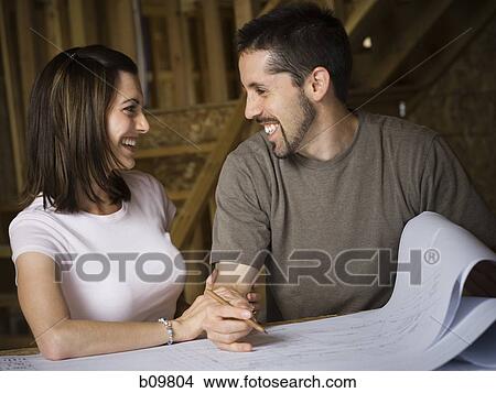 Young couple looking at each other and smiling View Large Photo Image Picture - Young couple looking at each other and smiling. Fotosearch
