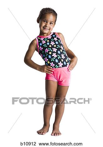 Stock Image - Young female gymnast with hands on hips. Fotosearch