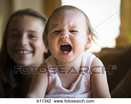 Young girl and her baby sister View Large Photo Image Stock Image - Young girl and her baby sister. Fotosearch
