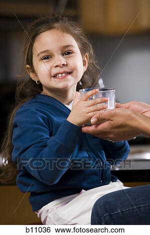Young girl drinking a glass of milk View Large Photo Image Stock Photograph - Young girl drinking a glass of milk. Fotosearch