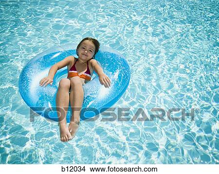 Young girl floating on life ring in swimming pool View Large Photo Image Picture - Young girl floating on life ring in swimming pool. Fotosearch