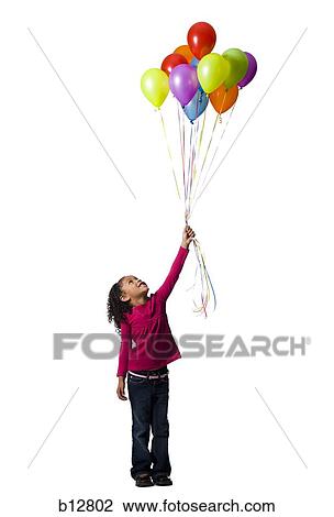 Young girl holding balloons View Large Photo Image Stock Image - Young girl holding balloons. Fotosearch