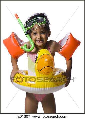 young girl in swimming gear smiles as she looks into the camera View Large Photo Image Stock Photo - young girl in swimming gear smiles as she looks into the camera. Fotosearch
