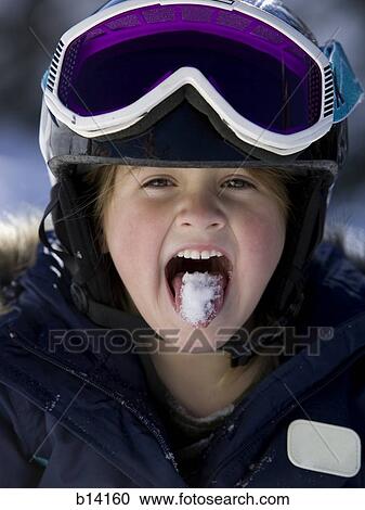 Young girl in winter with snow on tongue and ski goggles View Large Photo Image Stock Image - Young girl in winter with snow on tongue and ski goggles. Fotosearch