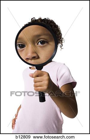 Young girl looking through magnifying glass View Large Photo Image Stock Photo - Young girl looking through magnifying glass. Fotosearch