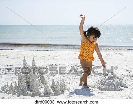 Young girl playing at beach with sand formations View Large Photo Image Stock Image - Young girl playing at beach with sand formations. Fotosearch