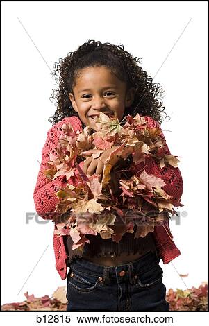 Young girl playing in fallen leaves View Large Photo Image Stock Photography - Young girl playing in fallen leaves. Fotosearch