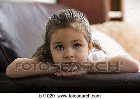 Young girl sitting on leather sofa View Large Photo Image Stock Image - Young girl sitting on leather sofa. Fotosearch