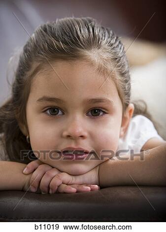 Young girl sitting on leather sofa View Large Photo Image Stock Photo - Young girl sitting on leather sofa. Fotosearch
