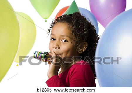 Young girl wearing party hat and playing amongst balloons View Large Photo Image Stock Photography - Young girl wearing party hat and playing amongst balloons. Fotosearch