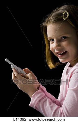 Young girl with cellular phone smiling View Large Photo Image Stock Image - Young girl with cellular phone smiling. Fotosearch