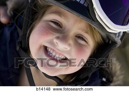 Stock Photo - Young girl with ski goggles smiling. Fotosearch