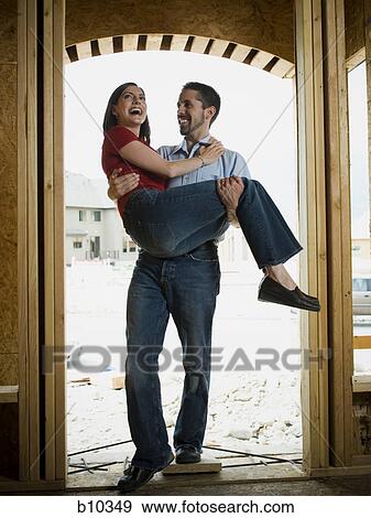 Young man carrying a young woman View Large Photo Image Stock Photo - Young man carrying a young woman. Fotosearch
