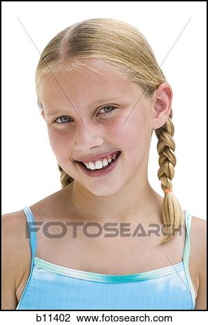 Stock Image - Young sisters on vacation playing with a beach ball. Fotosearch