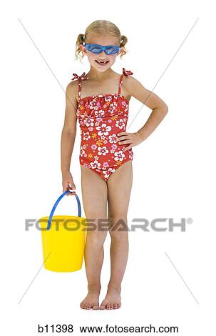 Young sisters on vacation playing with a beach ball View Large Photo Image Stock Photo - Young sisters on vacation playing with a beach ball. Fotosearch
