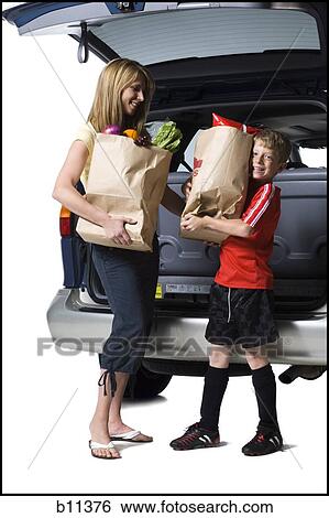 Young son helping mother with groceries View Large Photo Image Stock Photograph - Young son helping mother with groceries. Fotosearch