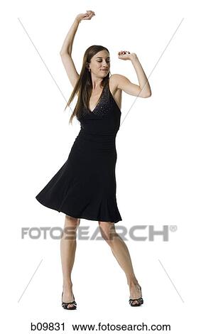 Young woman dancing with her arms raised View Large Photo Image Stock Image - Young woman dancing with her arms raised. Fotosearch