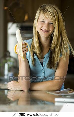 Young woman eating a banana View Large Photo Image Stock Image - Young woman eating a banana. Fotosearch