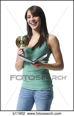 Young woman holding a DVD View Large Photo Image Stock Image - Young woman holding a DVD. Fotosearch