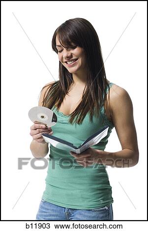 Young woman holding a DVD View Large Photo Image Stock Image - Young woman holding a DVD. Fotosearch