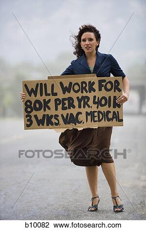 Young woman holding a work-wanted sign View Large Photo Image Stock Image - Young woman holding a work-wanted sign. Fotosearch