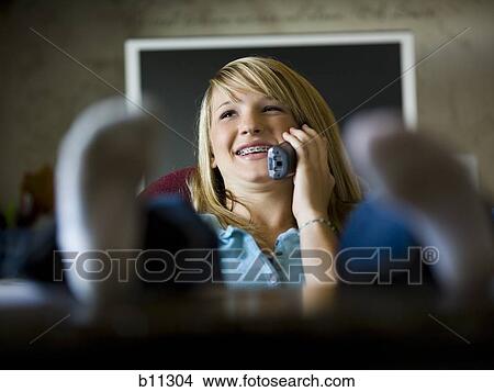 Young woman talking on phone View Large Photo Image Picture - Young woman talking on phone. Fotosearch