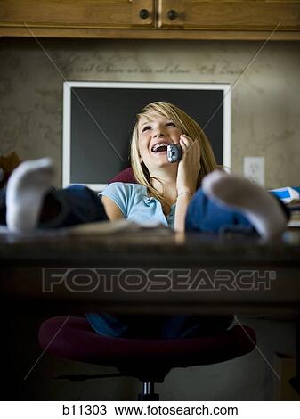 Young woman talking on phone View Large Photo Image Stock Image - Young woman talking on phone. Fotosearch