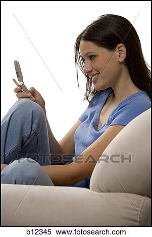 Stock Photography - Young woman with cell phone. Fotosearch