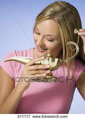Young woman with magic lantern making a wish View Large Photo Image Stock Photo - Young woman with magic lantern making a wish. Fotosearch
