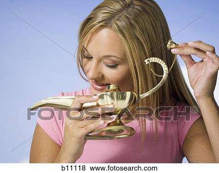 Young woman with magic lantern making a wish View Large Photo Image Stock Photo - Young woman with magic lantern making a wish. Fotosearch