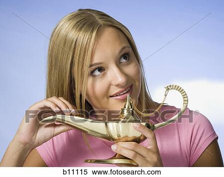 Stock Photography - Young woman with magic lantern making a wish. Fotosearch