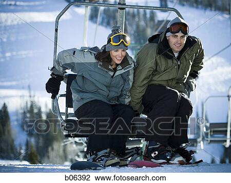Stock Image - A couple on a chairlift. Fotosearch