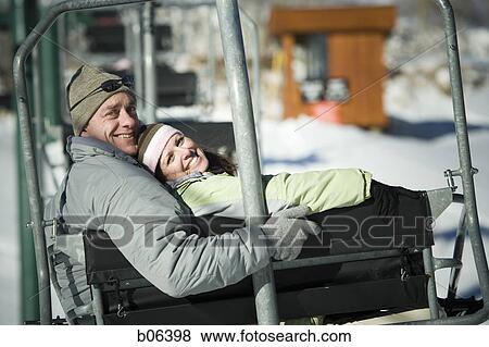 Stock Photo - A couple on a chairlift. Fotosearch