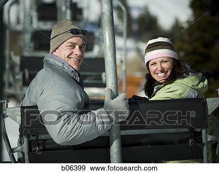 Stock Photo - A couple on a chairlift. Fotosearch