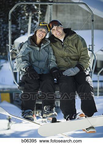 Stock Photography - A couple on a chairlift. Fotosearch