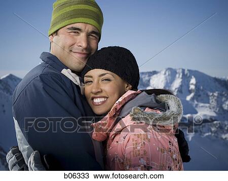 Stock Image - A couple outside in the snow. Fotosearch
