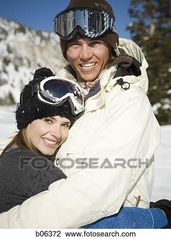 Stock Image - A couple outside in the snow. Fotosearch