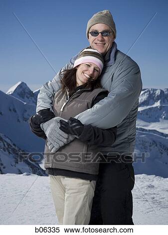Stock Photography - A couple outside in the snow. Fotosearch