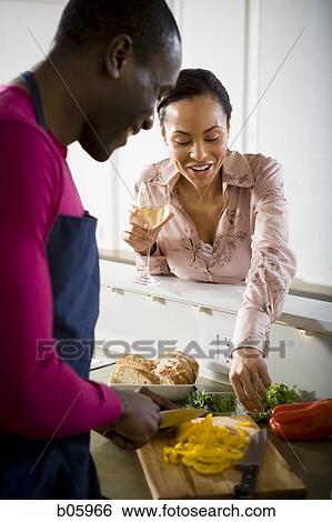 A couple preparing food View Large Photo Image Stock Photograph - A couple preparing food. Fotosearch