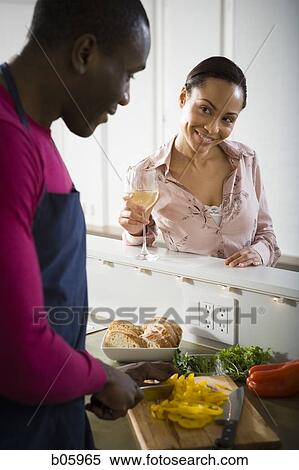 A couple preparing food View Large Photo Image Stock Photography - A couple preparing food. Fotosearch
