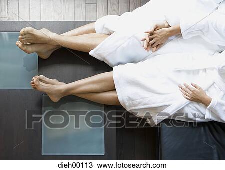 Stock Image - A couple relaxing in bathrobes. Fotosearch